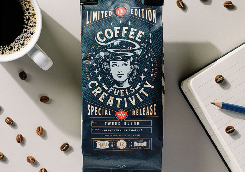 A packaging of coffee next to a notebook.