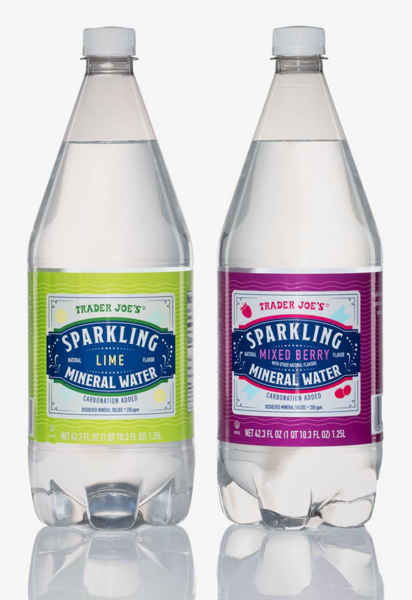 Two bottles of sparkling water on a white surface.